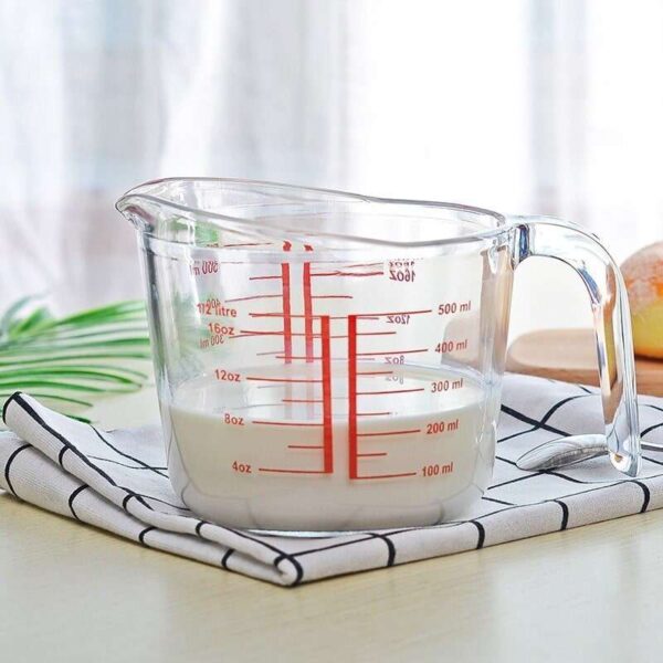 Glass measuring cup containing 8 ounces of milk.