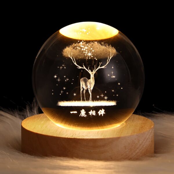 Crystal ball night light with 3D deer interior carving, emitting a soft warm glow, perfect for a cozy and mystical ambiance.