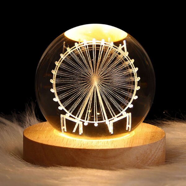Crystal ball night light with 3D ferris wheel interior carving, emitting a soft warm glow, perfect for a dreamy and magical ambiance.