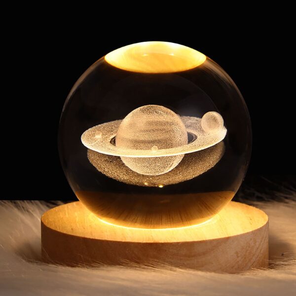Crystal ball night light with 3D saturn interior carving, emitting a soft warm glow, perfect for a dreamy and magical ambiance.